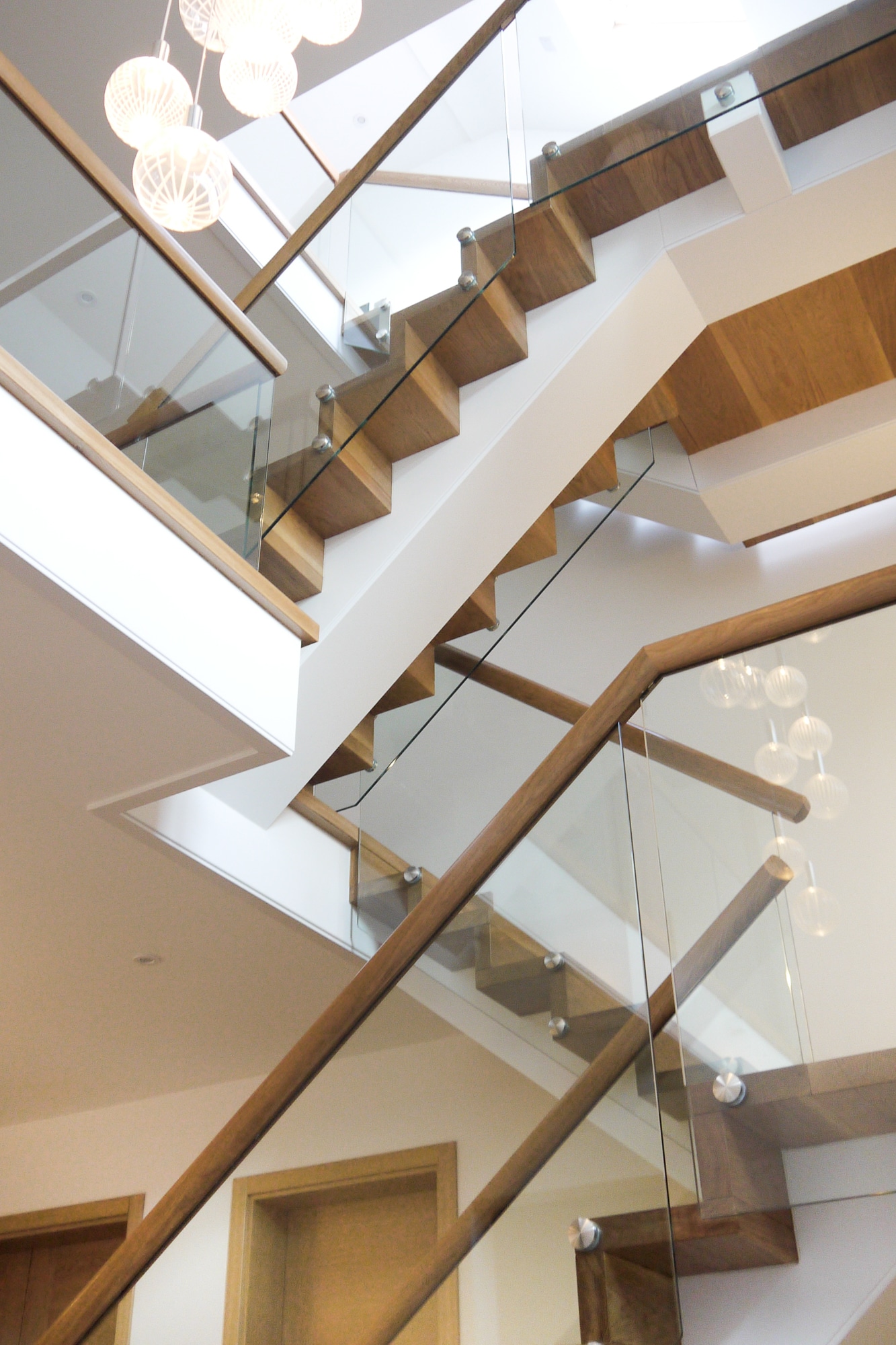 Oak carriage staircase with glass detail Elstree Hertfordshire